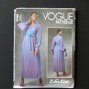 May include: Vogue Patterns sewing pattern envelope featuring a blue and pink striped dress with a wrap style bodice and long sleeves. The pattern is designed by Zandra Rhodes and is for size 12.