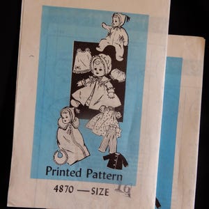 May include: Two vintage printed sewing patterns for baby clothes. The patterns feature illustrations of a baby in various outfits, including a coat, dress, and pajamas. The patterns are labeled "Printed Pattern 4870 - SIZE 16."