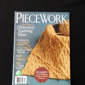 May include: A magazine cover for Piecework, a knitting magazine. The cover features a close-up of a knitted garment in a light brown color with knitting needles and yarn. The text on the cover reads "4th Annual Historical Knitting Issue".