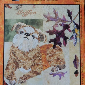 May include: A fabric quilt block titled "Summer's End" featuring a Brussels Griffon dog design. The quilt block has a beige background with autumn leaves and the text "Griffon". The design is by Maggie Walker Design.