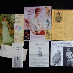 May include: A collection of vintage sewing and knitting patterns. The patterns include designs for dresses, skirts, and cardigans. The image features various printed leaflets and booklets with illustrations and text, including "The American Raglan Cardigan" and "Knit a Dress a Day..."