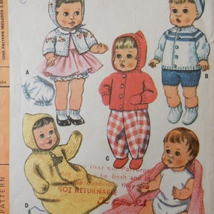 May include: Vintage doll clothing pattern from 1965. The pattern features illustrations of dolls in various outfits, including dresses, jackets, and rompers. The dolls are wearing knitted and sewn garments in pastel colors. The pattern includes sizes for Tiny Tears, Babykin, and other dolls.