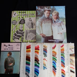 May include: A collection of vintage knitting patterns and yarn samples. The patterns, from "Mary Maxim," feature images of sweaters. One pattern is labeled "Spring Sale." Yarn color swatches are displayed, showcasing a variety of hues for knitting projects.
