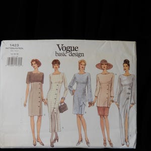 May include: Vogue Basic Design sewing pattern #1423 for sizes 14-18. The pattern features five different dress styles, including a short-sleeved dress with a contrasting top, a long-sleeved dress with a side slit, and a long-sleeved dress with a wrap detail.