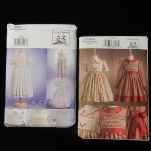 May include: Two vintage Vogue sewing pattern envelopes. One is white with a floral dress design, the other is beige and red with a dress design. Both feature illustrations of the finished garments and the designer's name.