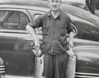 Two Hands Full,  proud fisherman by car, circa 1940's, measures approximately 5" X 7", 1947 Pontiac Torpedo Sedan, man with two fish, retro