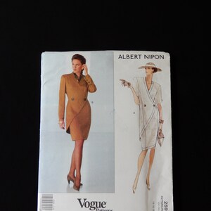May include: Vogue Patterns American Designer sewing pattern number 2595 for a dress designed by Albert Nipon. The pattern includes two views: a brown wrap dress with a collar and a white wrap dress with a collar.