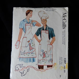 May include: Vintage McCall's sewing pattern for a Mr. and Mrs. apron set. The pattern is printed on white paper with a blue and red illustration of the aprons. The aprons feature a whimsical design with a chef and a woman holding a spatula. The pattern is for one size and costs 35 cents.