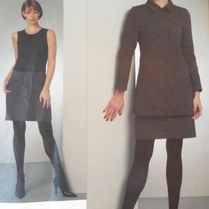 May include: A sewing pattern envelope for DKNY Donna Karan New York Vogue American Designer clothing. The front displays two outfits: a sleeveless black top with a grey skirt, and a long-sleeved dark grey jacket with a matching skirt and tights.