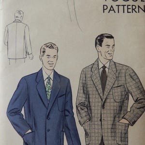 May include: Vintage Vogue Pattern 6898 featuring illustrations of two men's blazers. One blazer is blue, the other is gray plaid. The pattern includes a sketch of the back of a blazer and the text "Vogue Pattern".