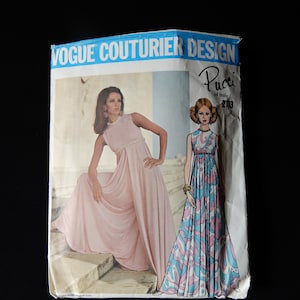 May include: Vogue Couturier Design pattern for a dress by Pucci of Italy, pattern number 2113. The pattern shows two models wearing the dress, one in a solid pink color and the other in a blue and pink floral print.