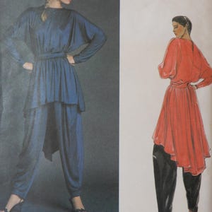May include: Vogue International Designers pattern featuring two women modeling outfits. One woman wears a blue tunic and matching pants, the other a red tunic and black pants. The Vogue logo is visible.