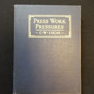 May include: A blue hardcover book with the title "Press Work Pressures" and the author "C.W. Lucas" on the front cover.