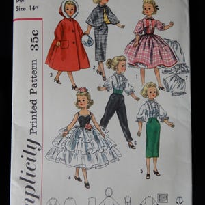 May include: Simplicity Printed Pattern 2293 for a 14 inch doll. The pattern includes instructions for making seven different outfits, including a red coat, a plaid skirt, a black dress with ruffles, a green skirt, a white blouse, a black and white skirt, and a white petticoat.