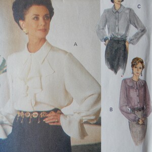May include: A vintage sewing pattern featuring a woman in a white blouse with a ruffled collar and long sleeves, paired with a dark skirt. The pattern also includes illustrations of similar blouses in different colors and styles. The pattern number is 8759/120.