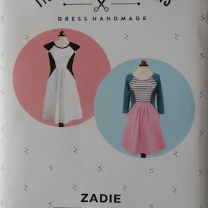 May include: A sewing pattern titled "Zadie" by Tilly and the Buttons, featuring illustrations of two dresses. One dress is white with black accents, the other is pink and blue. The text "Make it Yourself" is also visible.
