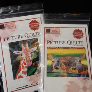 May include: Two clear plastic bags containing quilt patterns by Malec Designs. The left package features a giraffe illustration and text stating Over 50 Patterns Available. The right package shows a hippo illustration and text stating Over 60 Patterns Available.