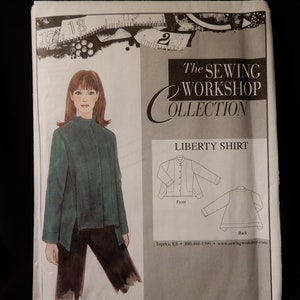 May include: A sewing pattern for a Liberty Shirt from The Sewing Workshop Collection. The pattern shows a woman wearing a green shirt with a collar and long sleeves. The pattern also includes a front and back view of the shirt.