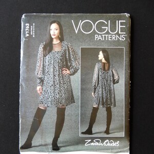 May include: Vogue Patterns sewing pattern for a dress with a sheer yoke and long sleeves. The pattern is for size 8-18 and is designed by Zandra Rhodes. The pattern is on a white background with black text.