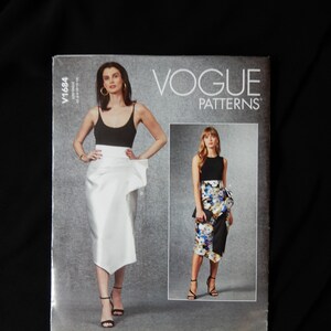 May include: Vogue Patterns sewing pattern for a skirt, featuring two models wearing different versions of the skirt. The model on the left is wearing a white skirt with a draped design, while the model on the right is wearing a black and white floral skirt with a ruffle detail. The pattern number is V1684.
