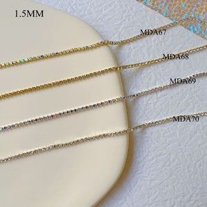 May include: Four strands of 1.5mm rhinestone chain in gold and silver tones. The chains are labeled MDA67, MDA68, MDA69, and MDA70.
