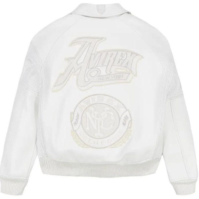 May include: A white leather bomber jacket featuring a classic collar, ribbed cuffs, and a ribbed hem. The back displays large embroidered patches with the text Avirex New York and a circular logo with the letters NYC and the words Trade Mark.