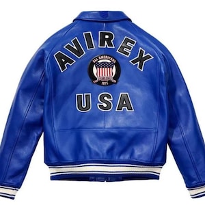 May include: A bright blue leather varsity jacket featuring the text AVIREX in black letters across the upper back. Below the text is a circular patch with an American flag design and the words All Americans Established 1975. USA is printed below.