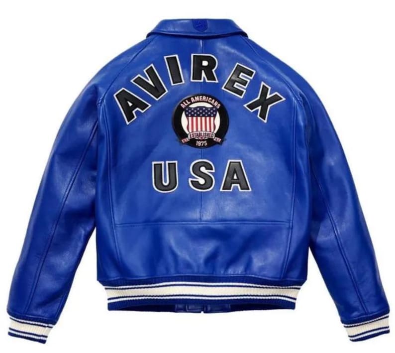 May include: A bright blue leather varsity jacket featuring the text AVIREX in black letters across the upper back. Below the text is a circular patch with an American flag design and the words All Americans Established 1975. USA is printed below.