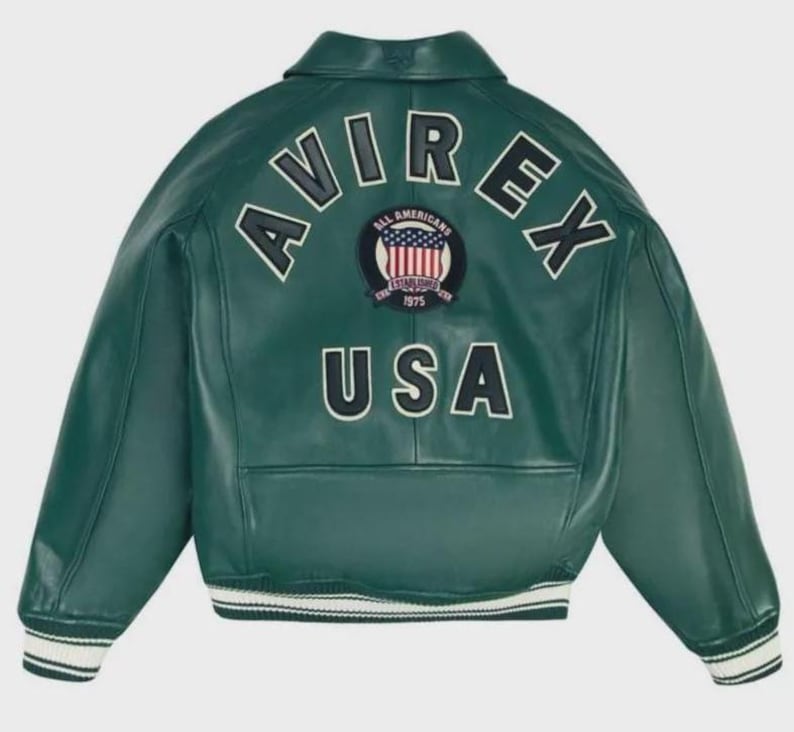 May include: A green leather jacket with the word "AVIREX" in white block letters across the back. Below the word "AVIREX" is a patch with the words "ALL AMERICANS ESTABLISHED 1975" and a graphic of the American flag. The word "USA" is below the patch.