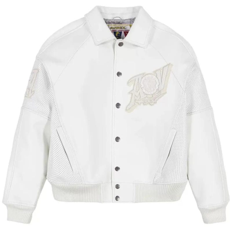 May include: A white varsity jacket featuring a classic collar, snap-button front closure, and ribbed cuffs and hem. The jacket includes perforated side panels, two front pockets, and a large embroidered patch on the chest with the text AVIREX.
