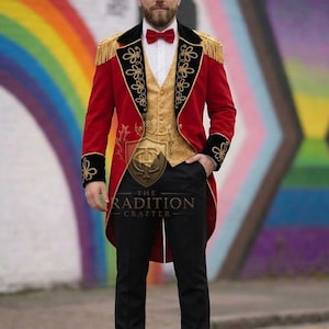 May include: A red tailcoat jacket with gold fringe epaulets and black velvet lapels featuring gold embroidery, worn over a gold vest, white shirt, and red bow tie. Black trousers and black dress shoes complete the ensemble.
