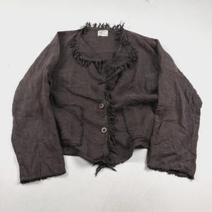 May include: A dark brown long-sleeved jacket featuring a round neckline, two front buttons, and two patch pockets. The garment is detailed with frayed, raw-edge trim along the collar, front opening, and cuffs, and includes a small white label.