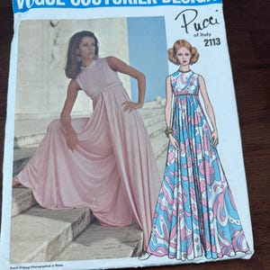 May include: A Vogue Couturier Design sewing pattern envelope for Pucci of Italy, number 2113. The cover features a photograph of a floor-length sleeveless dress in solid pink and an illustration of the same dress in a blue, pink, and white pattern.