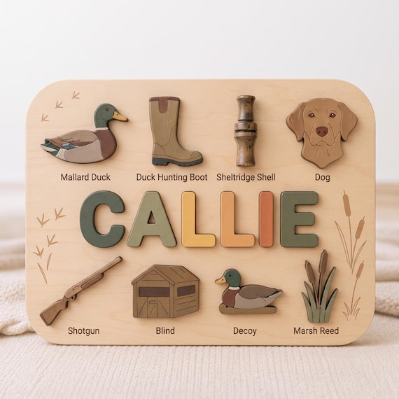A name puzzle shaped around a full hunting scene — mallard duck, shotgun, boots — making it both a toddler toy and a tiny piece of folk art for the hunting family.