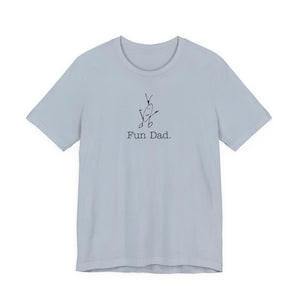 May include: A light blue t-shirt with a crew neck. The shirt features a whimsical black line drawing of a figure with the text "Fun Dad." The design is centered on the front of the shirt.