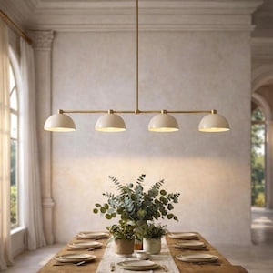 May include: A linear pendant light fixture featuring a long horizontal brass rod suspended from a single vertical stem. The fixture includes four evenly spaced, downward-facing dome-shaped shades in a matte off-white finish with brass accents.