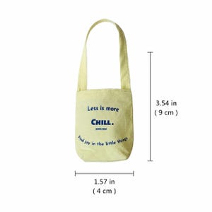 Yellow miniature canvas tote bag shown with size reference, measuring about 3.54 by 1.57 inches.