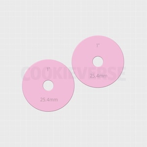 May include: Two light pink circular discs with a central hole, each featuring the printed text 1 inch and 25.4mm. The items are arranged diagonally against a light grid background, displaying a flat, uniform color and a simple geometric shape.