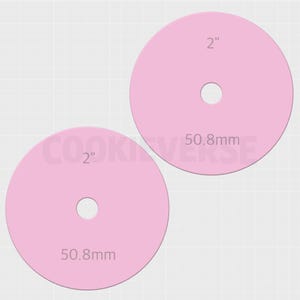 May include: Two light pink circular discs, each featuring a central circular cutout. The discs are labeled with the text 2" and 50.8mm, indicating a diameter of 2 inches or 50.8 millimeters. The items are displayed against a light grid background.