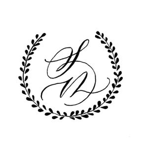 May include: Black and white monogram design featuring the intertwined letters "S" and "Z" in elegant script. The letters are encircled by a detailed laurel wreath, creating a classic and sophisticated emblem.