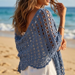May include: A dusty blue crochet shawl featuring an openwork diamond pattern with a scalloped edge. The garment is draped over the shoulders, showcasing the intricate yarn texture and the lightweight, airy construction of the handmade textile design.