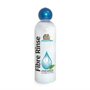 May include: A white bottle of "Fibre Rinse" with a blue cap. The bottle features a logo of a unicorn and a water droplet design. Text on the bottle indicates it is anti-static conditioning for fabrics and knitwear, 16 fl oz (473ml).