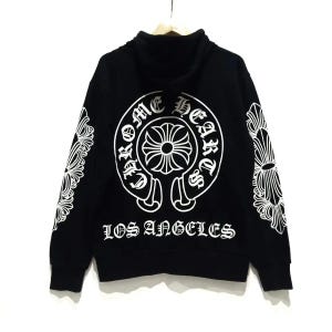 May include: Black hoodie with a high collar and white graphic designs. The back features a large circular emblem with the words "Chrome Hearts" and "Los Angeles". White floral designs are on the sleeves.