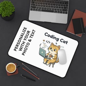May include: A rectangular white desk mat featuring a black border and a cartoon illustration of an orange cat sitting on a stool, using a laptop and holding a mug. The text reads "PERSONALIZE WITH YOUR PHOTO & TEXT" and "Coding Cat" with code symbols.