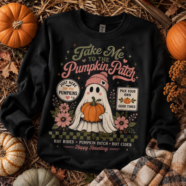 May include: A black crewneck sweatshirt featuring a graphic of a ghost wearing a pink beanie and holding an orange pumpkin. The text reads Take Me To The Pumpkin Patch, Just Here For The Pumpkins, Pick Your Own Good Times, Hay Rides, Pumpkin Patch, Hot Cider, and Happy Haunting, surrounded by flowers and a checkered pattern.