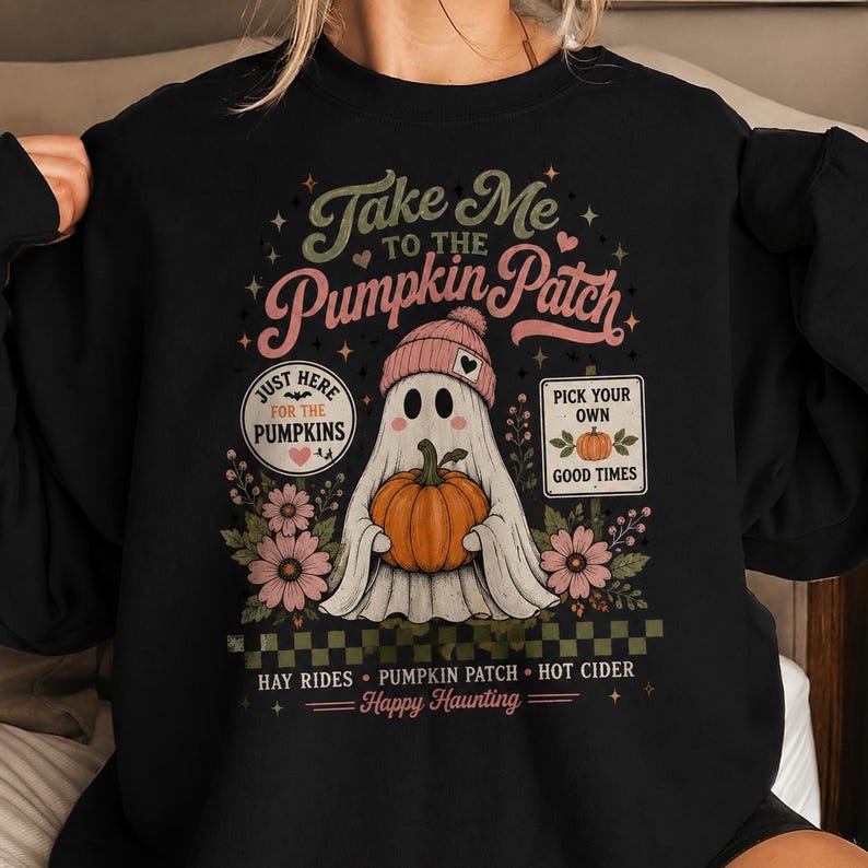 May include: A black long-sleeve sweatshirt featuring a graphic of a ghost wearing a pink beanie and holding an orange pumpkin. The text reads: Take Me To The Pumpkin Patch, Just Here For The Pumpkins, Pick Your Own Good Times, Hay Rides, Happy Haunting.