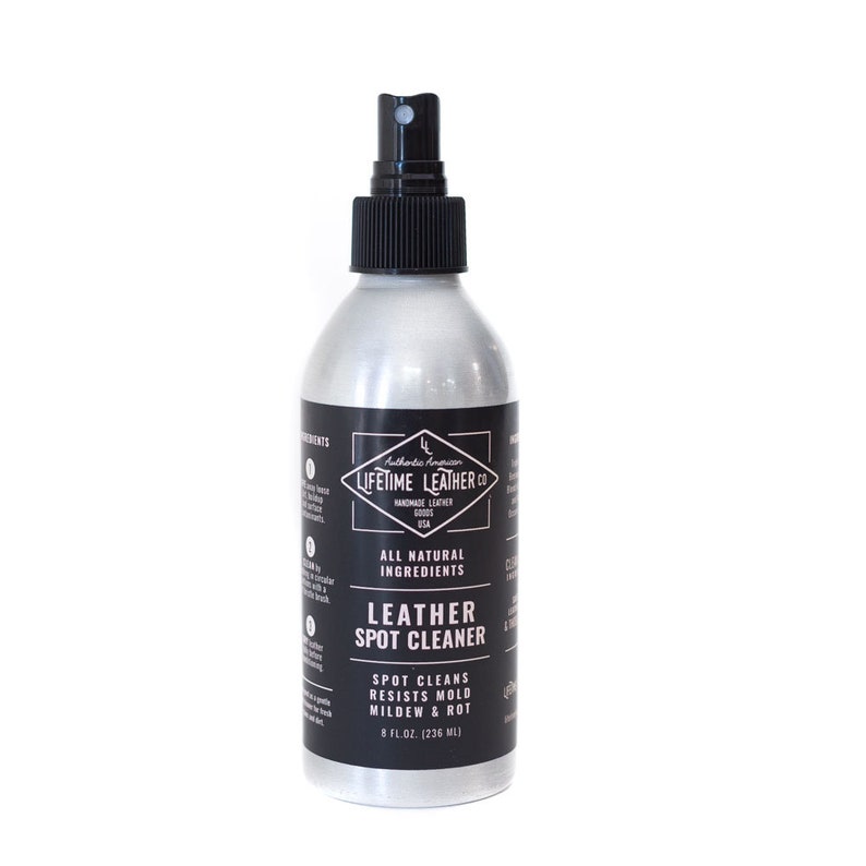 May include: A silver spray bottle with a black label that reads "Lifetime Leather Co. All Natural Ingredients Leather Spot Cleaner. Spot Cleans Resists Mold Mildew & Rot 8 fl.oz. (236 ml)"