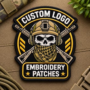 May include: A circular embroidered patch featuring a skull wearing a tan tactical helmet and a camouflage neck gaiter. Two rifles are crossed behind the skull. The text CUSTOM LOGO appears at the top and EMBROIDERY PATCHES at the bottom in white.