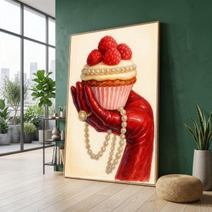 May include: A vertical wall art print featuring a hand wearing a glossy red glove holding a cupcake topped with fresh raspberries and a string of white pearls. The hand also wears a gold ring with a pearl, set against a cream-colored background.