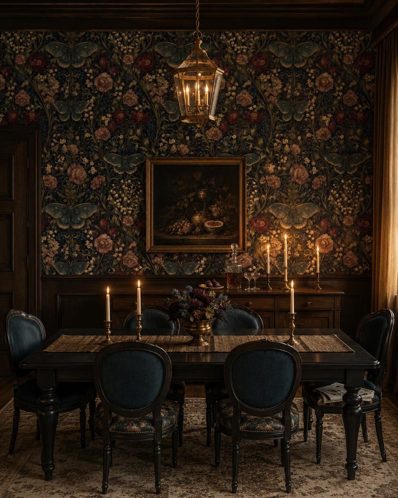 May include: A dark dining room featuring a rectangular black wooden table surrounded by four chairs with blue upholstered seats. A long woven runner sits on the table with brass candlesticks, lit candles, and a central floral arrangement in a brass bowl.